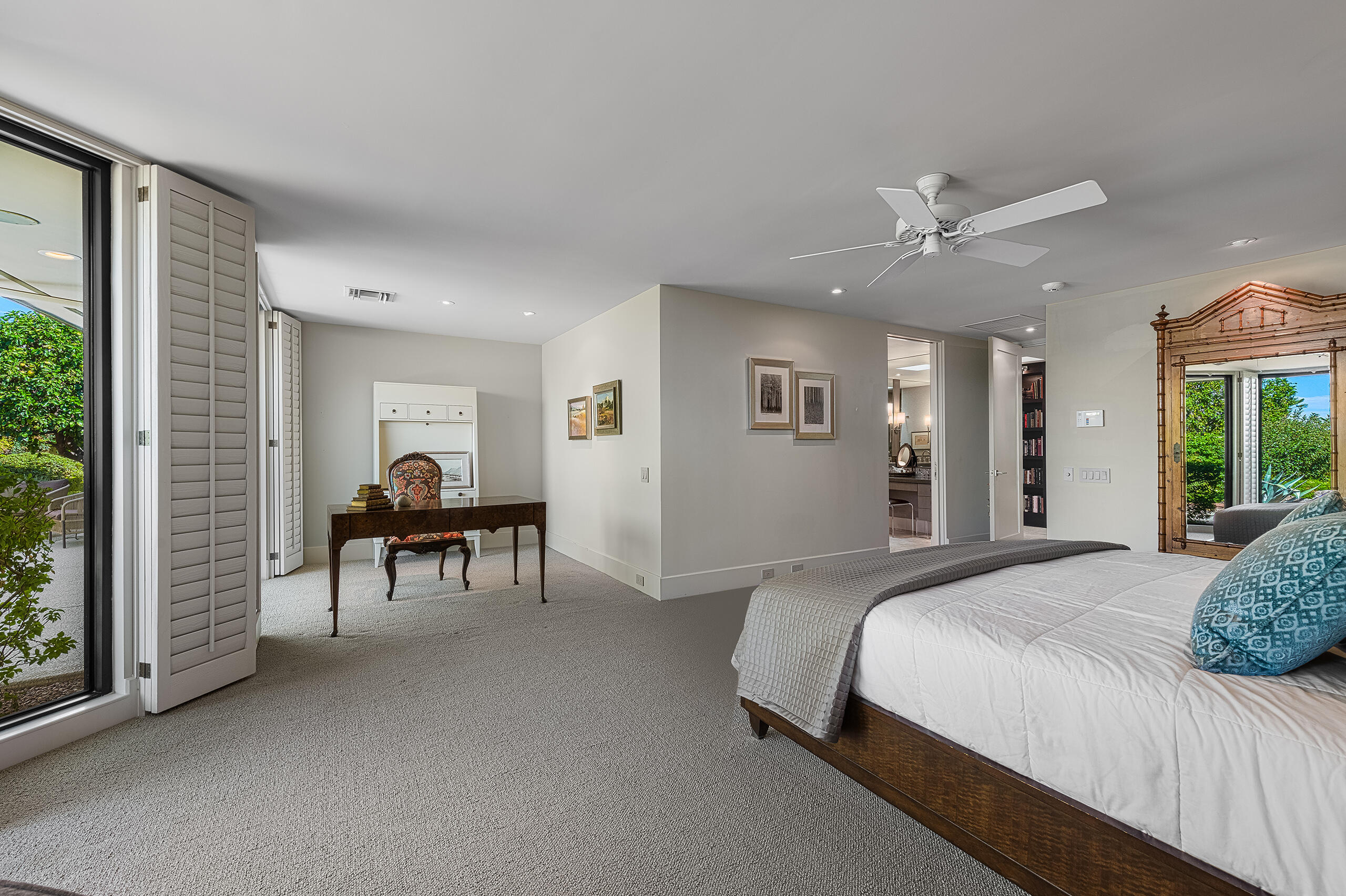 18 Creekside Drive Rancho Mirage, CA 92270 - Photo 27 of 40 a spacious bedroom with a bed and a chandelier