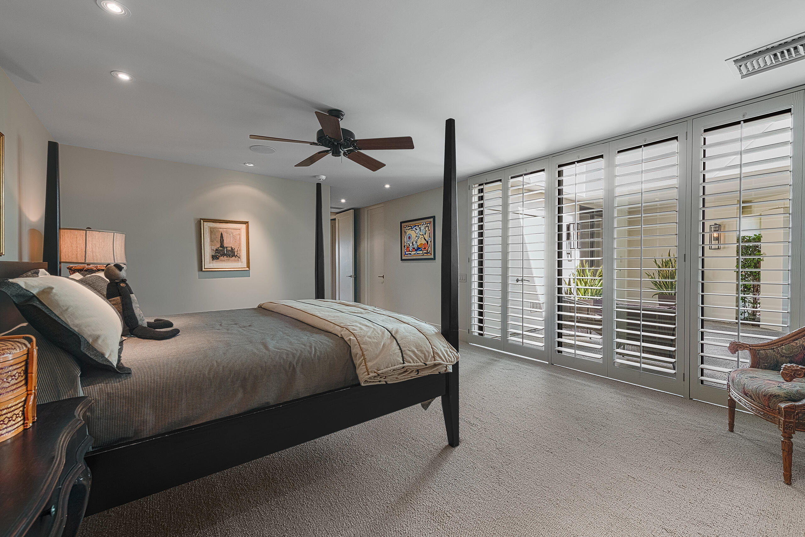 18 Creekside Drive Rancho Mirage, CA 92270 - Photo 32 of 40 a bedroom with a large bed and a chandelier fan