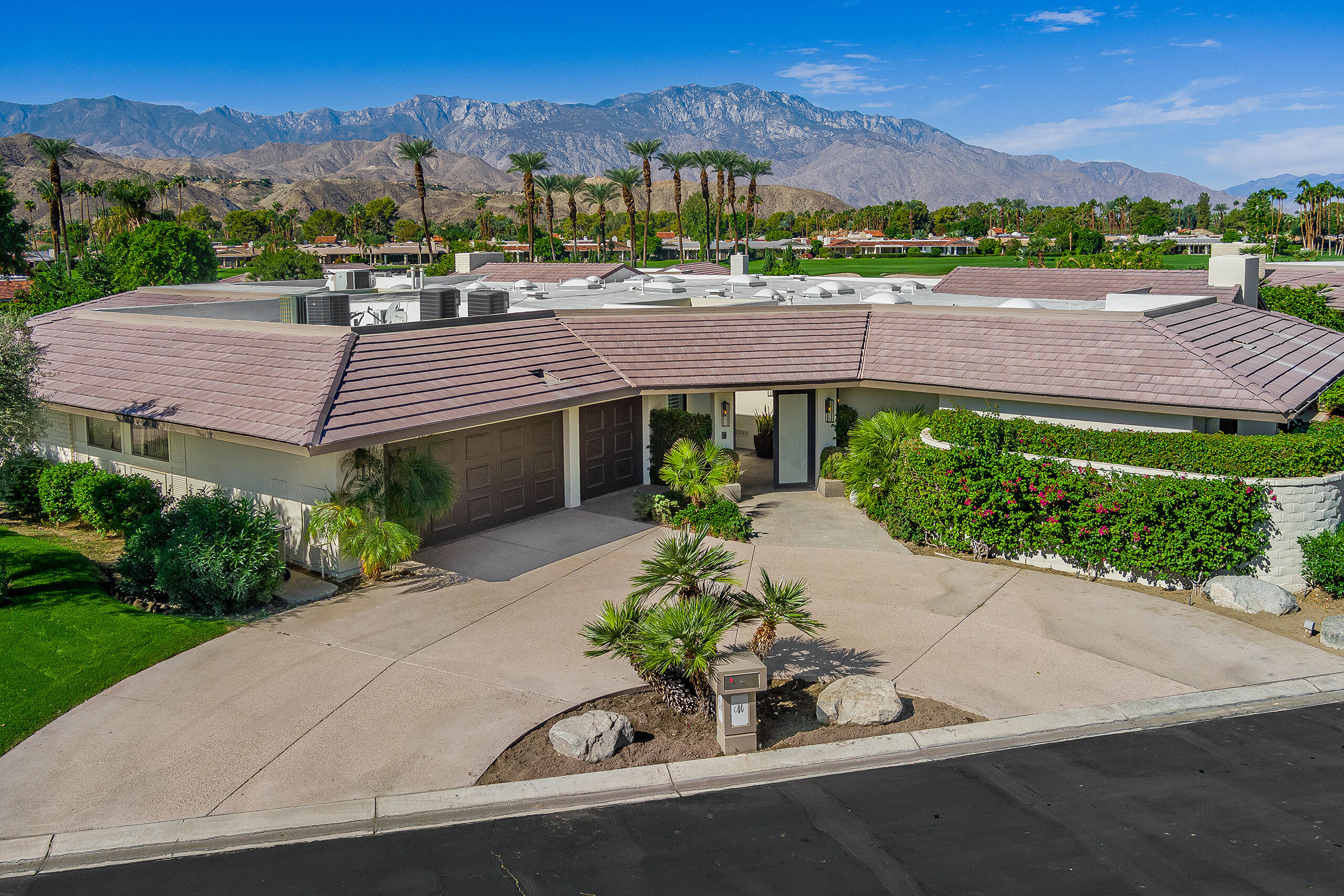 18 Creekside Drive Rancho Mirage, CA 92270 - Photo 39 of 40 a view of a house with a yard and a garden