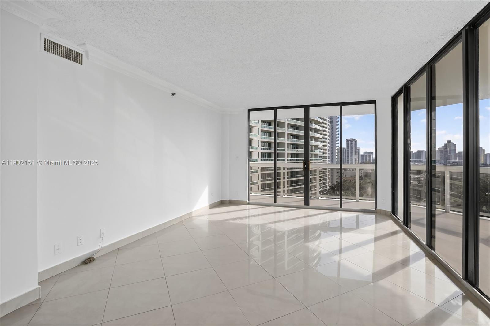 20185 East Country Club Drive, Unit 1405 Aventura, FL 33180 - Photo 11 of 67 a view of an empty room with a balcony