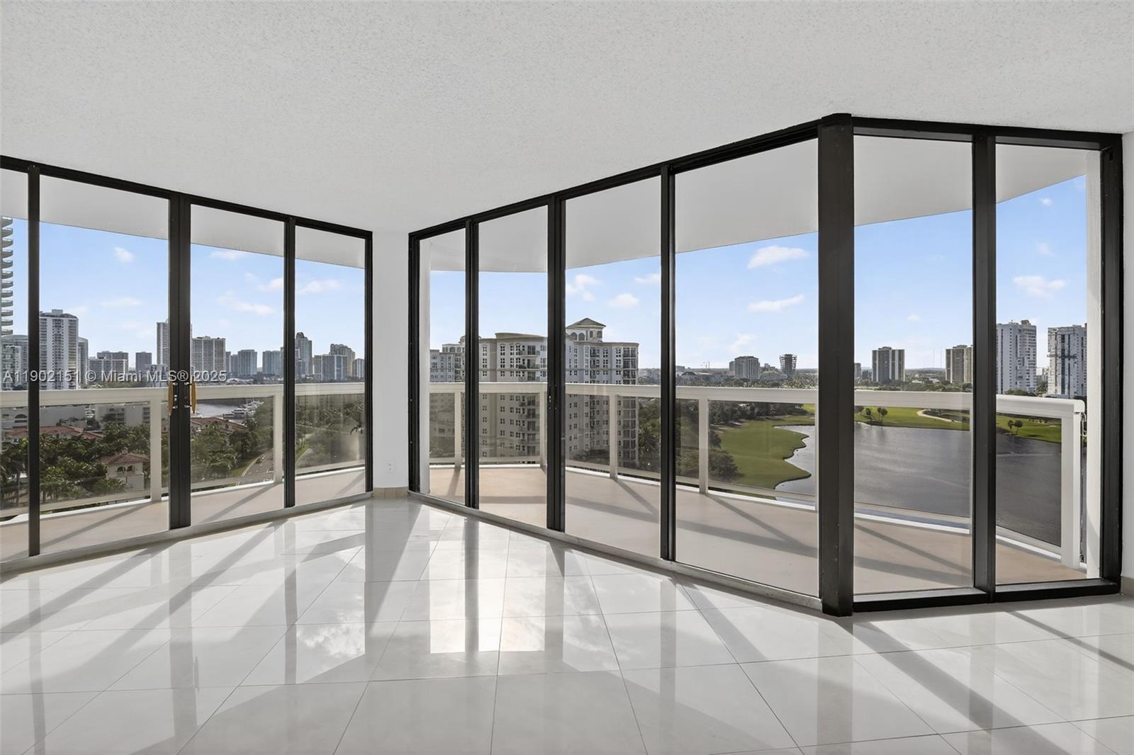 20185 East Country Club Drive, Unit 1405 Aventura, FL 33180 - Photo 13 of 67 a view of an empty room and windows