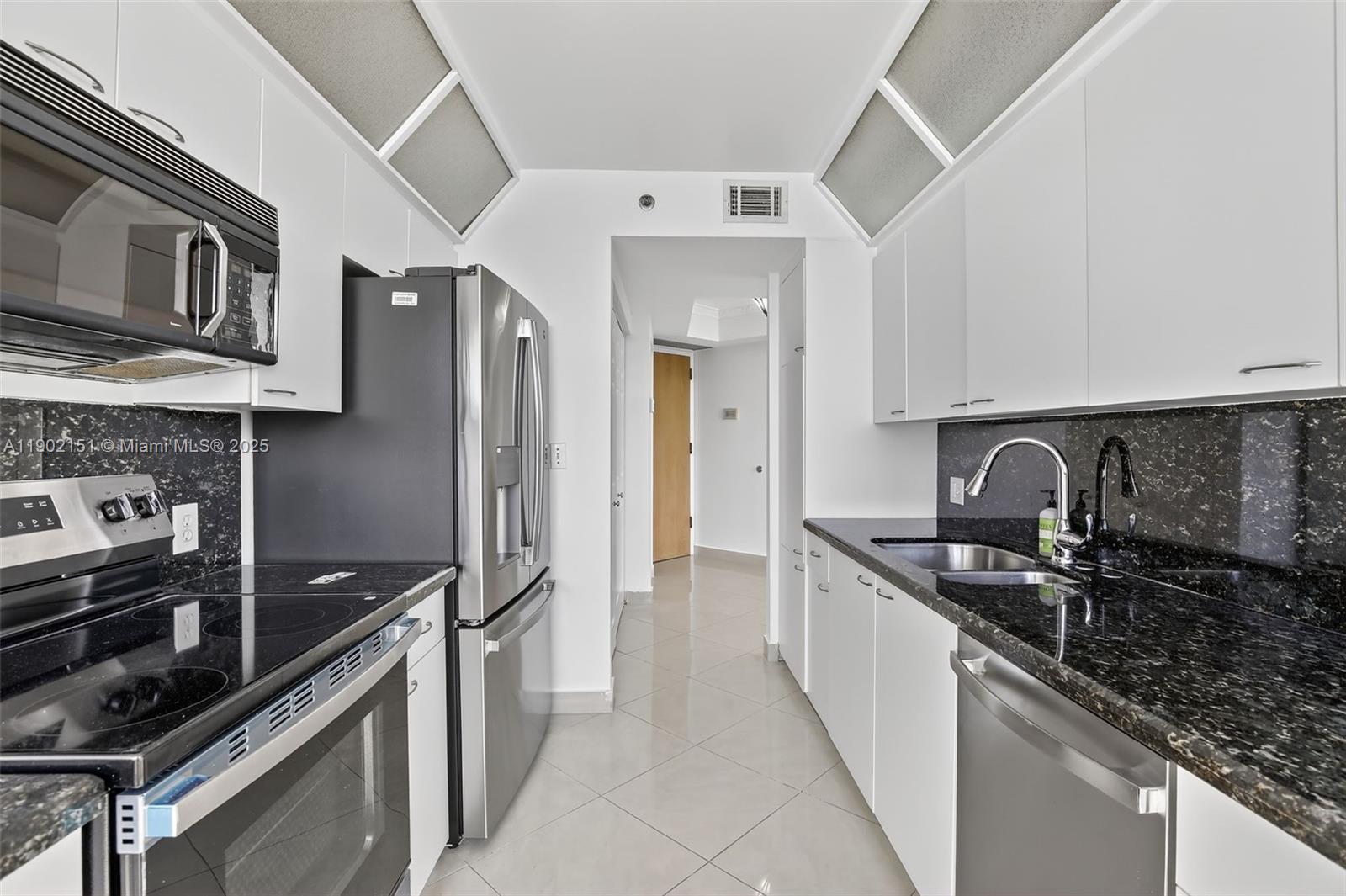 20185 East Country Club Drive, Unit 1405 Aventura, FL 33180 - Photo 18 of 67 a kitchen with stainless steel appliances granite countertop a sink and a stove