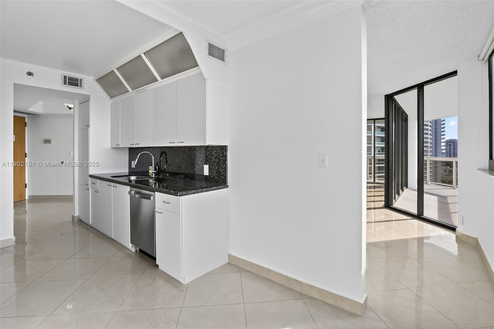 20185 East Country Club Drive, Unit 1405 Aventura, FL 33180 - Photo 19 of 67 a kitchen with stainless steel appliances a stove a microwave and a refrigerator