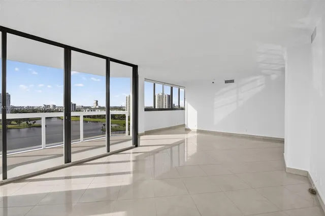 an empty room with sliding glass door and outer view