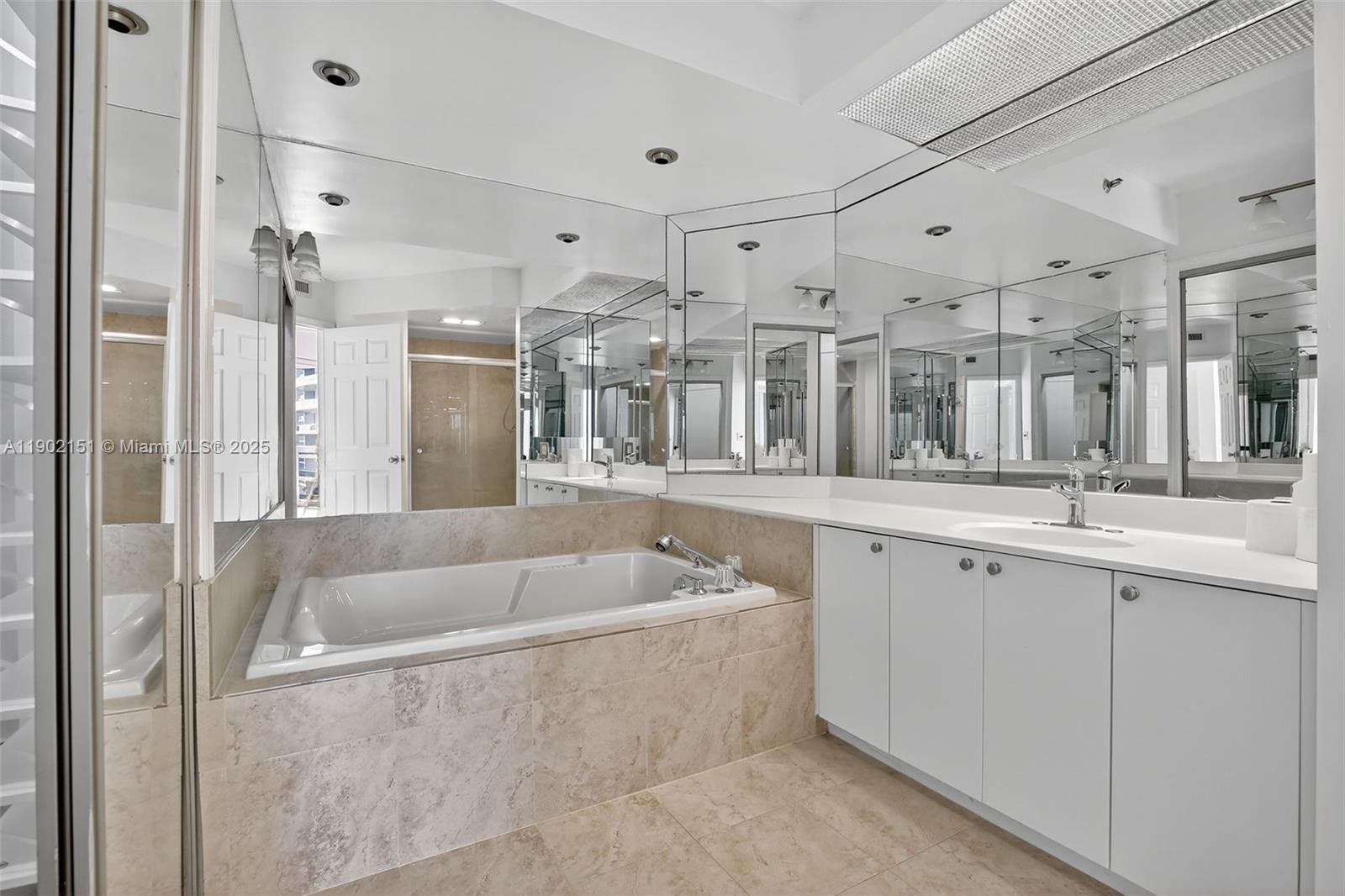 20185 East Country Club Drive, Unit 1405 Aventura, FL 33180 - Photo 27 of 67 a spacious bathroom with a tub a sink shower and mirror