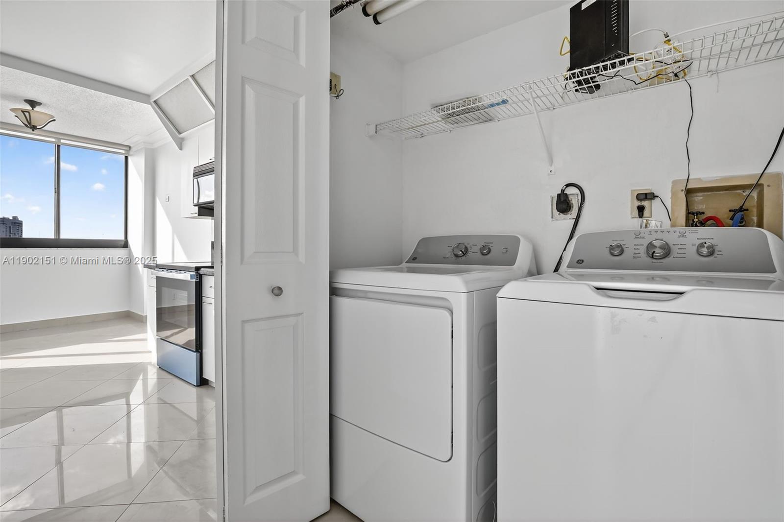 20185 East Country Club Drive, Unit 1405 Aventura, FL 33180 - Photo 34 of 67 a utility room with dryer and washer