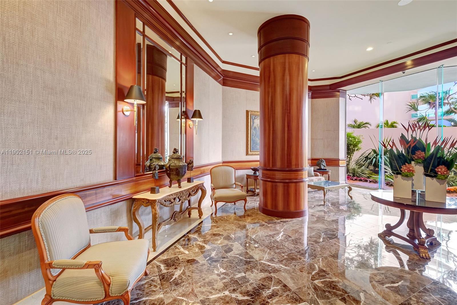 20185 East Country Club Drive, Unit 1405 Aventura, FL 33180 - Photo 43 of 67 a lobby with furniture and floor to ceiling window