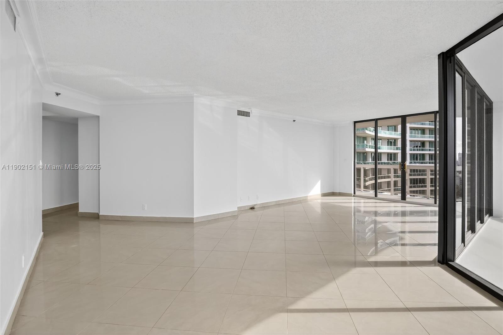 20185 East Country Club Drive, Unit 1405 Aventura, FL 33180 - Photo 10 of 67 an empty room with windows