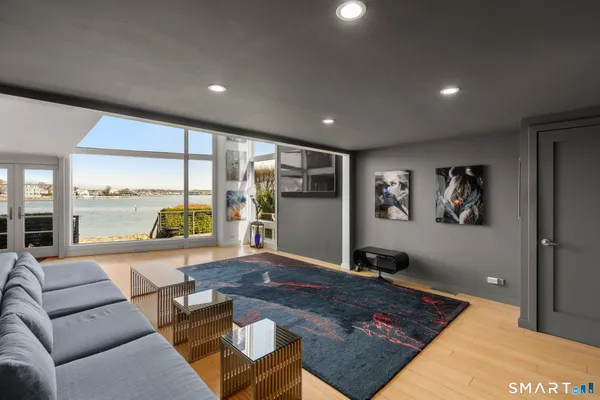 a living room with furniture and large window