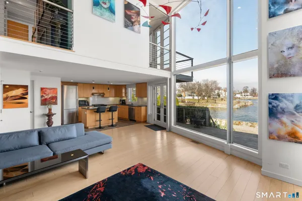 a living room with furniture and a floor to ceiling window