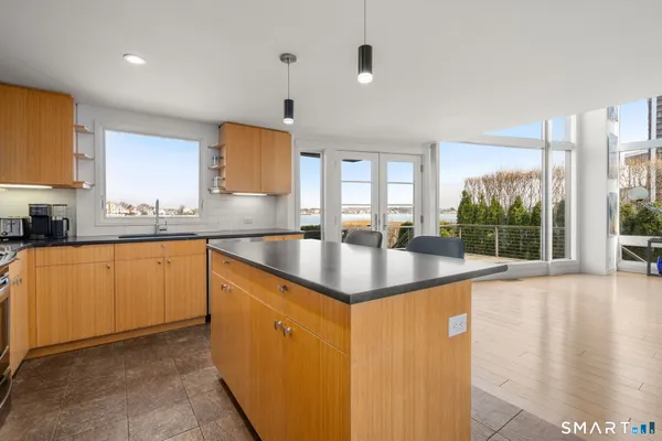 a kitchen with granite countertop a sink and white cabinets