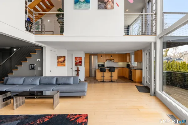 a living room with furniture and kitchen view