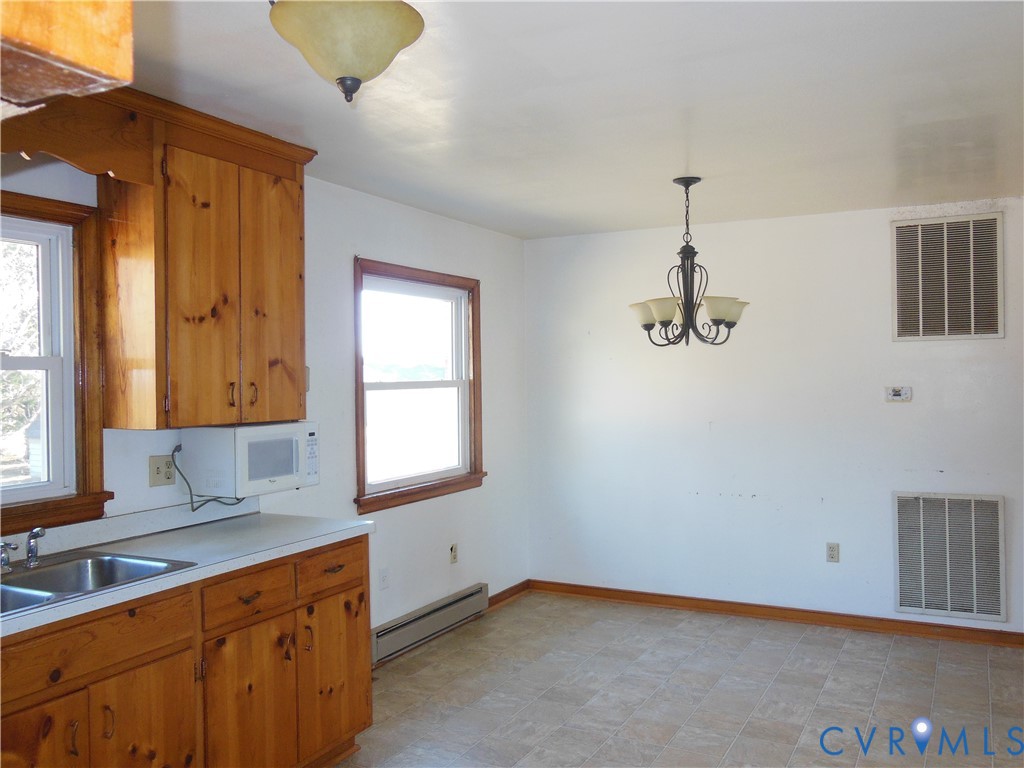 15647 Scotchtown Road Montpelier, VA 23192 - Photo 7 of 18 a kitchen with a sink cabinets and window