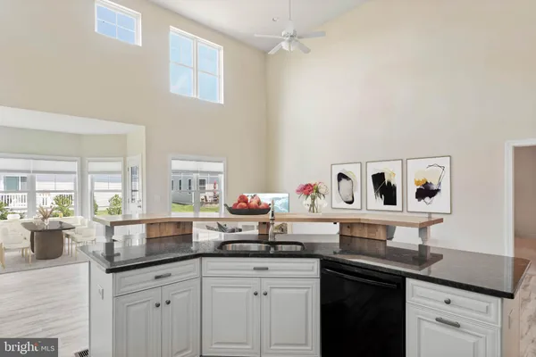 a kitchen with granite countertop a sink cabinets and window