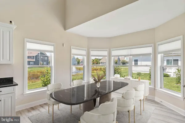 a dining room with furniture and window