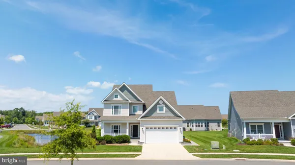 a front view of a residential houses with yard