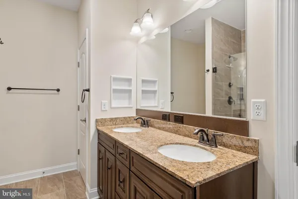 a bathroom with a granite countertop sink and a mirror