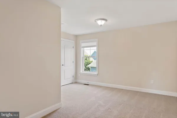 a view of an empty room and closet area