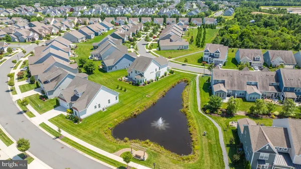 an aerial view of a house with a garden and swimming pool