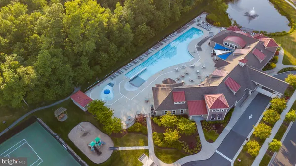 an aerial view of residential houses with outdoor space and trees