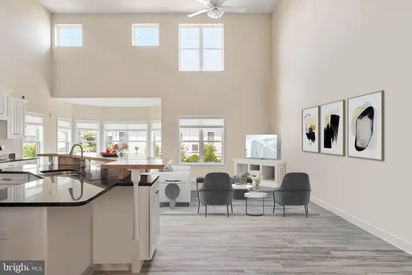 a living room with furniture a wooden floor and a large window