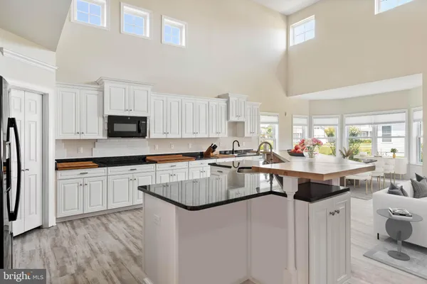 a kitchen with kitchen island granite countertop lots of counter top space and stainless steel appliances