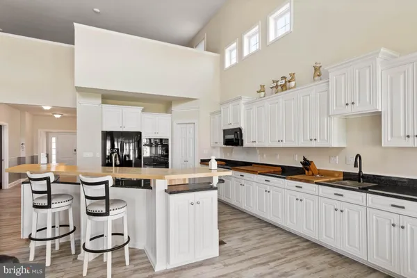 a kitchen with stainless steel appliances kitchen island granite countertop a sink and cabinets