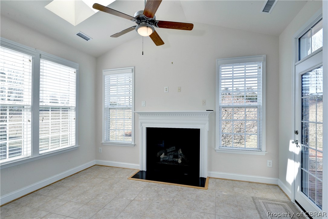 4244 Old Lock Road Williamsburg, VA 23188 - Photo 8 of 31 The tiled sun room has skylights and a gas fireplace.