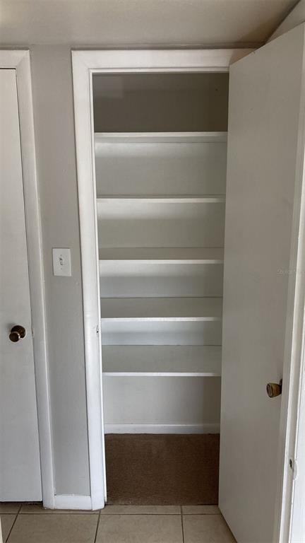 3718 West McKay Avenue, Unit 206 Tampa, FL 33609 - Photo 18 of 21 a view of walk in closet with empty racks