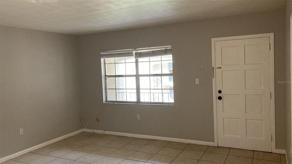 3718 West McKay Avenue, Unit 206 Tampa, FL 33609 - Photo 4 of 21 an empty room with windows