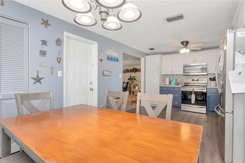 a large kitchen with a table and chairs