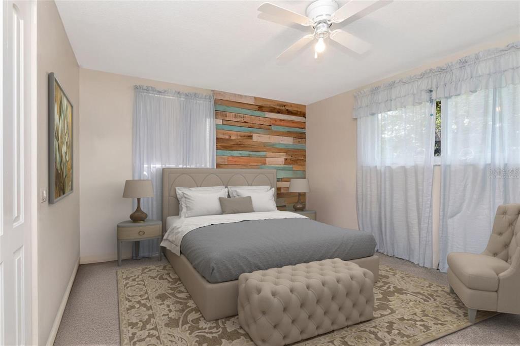 10301 Orchid Drive Port Richey, FL 34668 - Photo 14 of 35 a bedroom with a bed and a chandelier