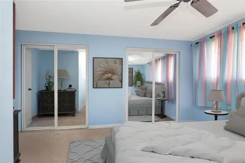 a bedroom with a bed and a mirror