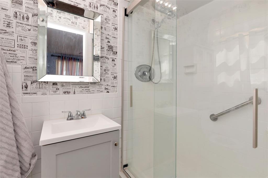 10301 Orchid Drive Port Richey, FL 34668 - Photo 17 of 35 a bathroom with a sink mirror and shower