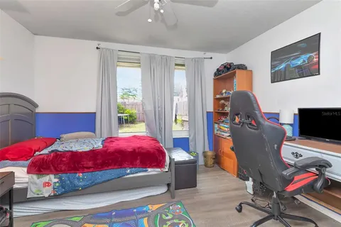 a bedroom with a bed and wooden floor