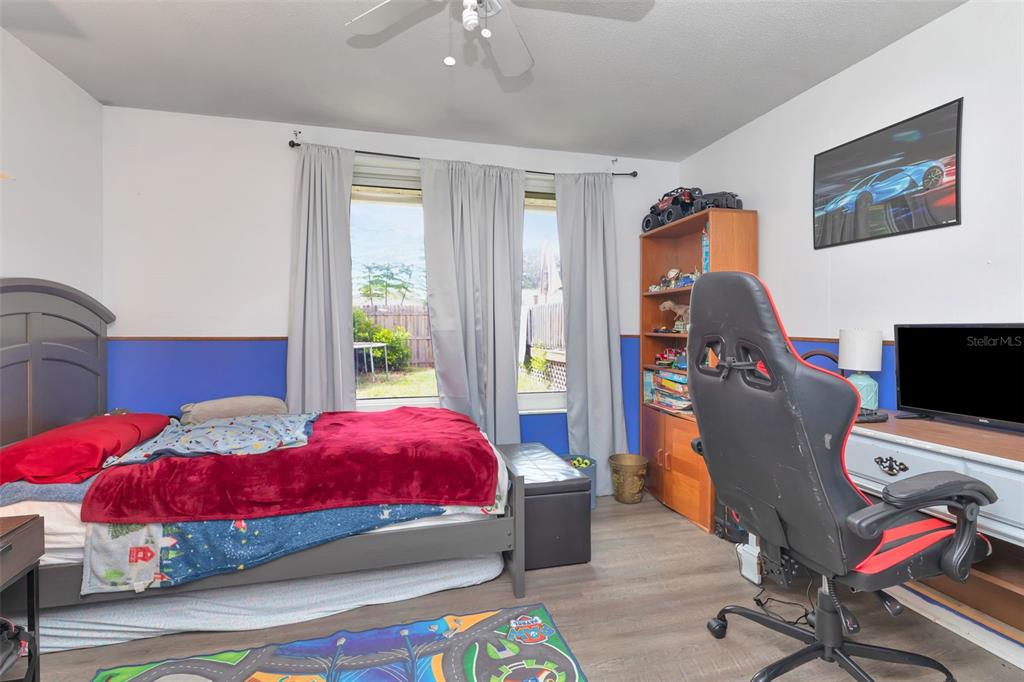 10301 Orchid Drive Port Richey, FL 34668 - Photo 18 of 35 a bedroom with a bed and wooden floor