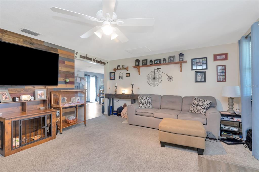 10301 Orchid Drive Port Richey, FL 34668 - Photo 24 of 35 a living room with furniture and a flat screen tv