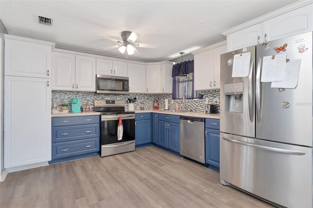 10301 Orchid Drive Port Richey, FL 34668 - Photo 25 of 35 a kitchen with a refrigerator and a stove top oven