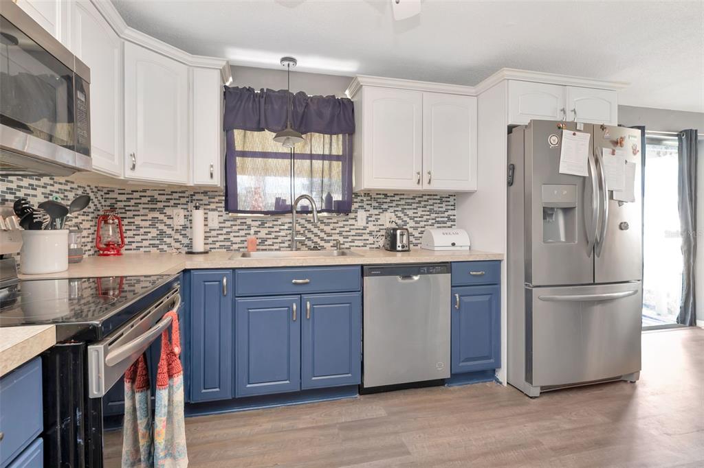 10301 Orchid Drive Port Richey, FL 34668 - Photo 26 of 35 a kitchen with stainless steel appliances granite countertop a refrigerator sink and cabinets