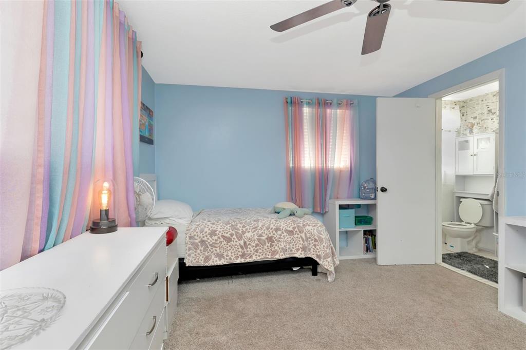 10301 Orchid Drive Port Richey, FL 34668 - Photo 28 of 35 a bedroom with a bed and a table in it