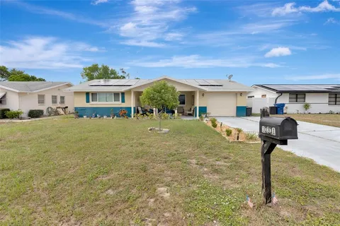 a front view of house with yard and green space