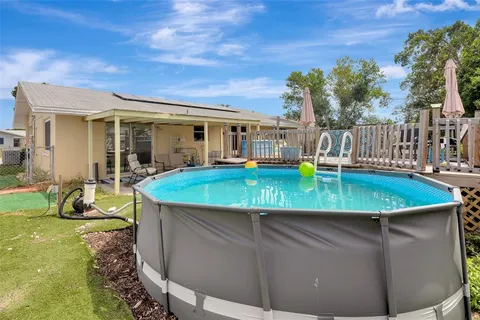 a view of a house with swimming pool and sitting area