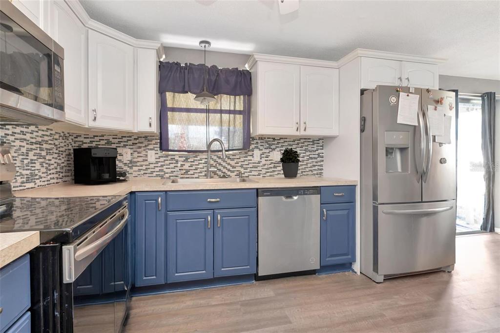 10301 Orchid Drive Port Richey, FL 34668 - Photo 9 of 35 a kitchen with a refrigerator sink and cabinets