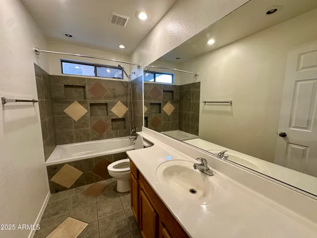 a bathroom with a sink mirror toilet and bathtub