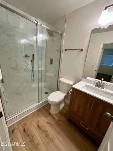 a bathroom with a sink toilet and shower