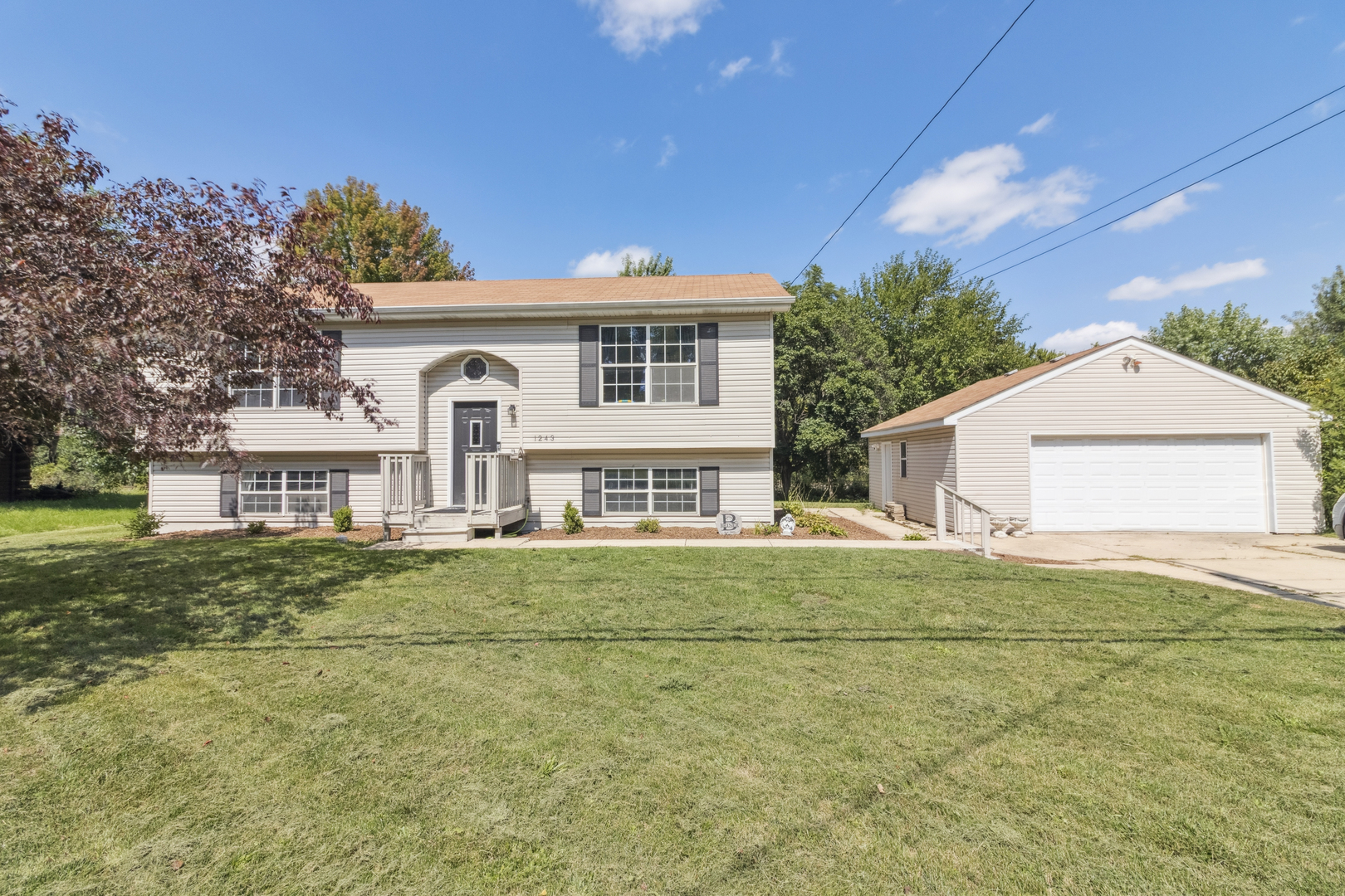 1243 Jericho Road Aurora, IL 60506 - Photo 1 of 25 a front view of a house with a garden
