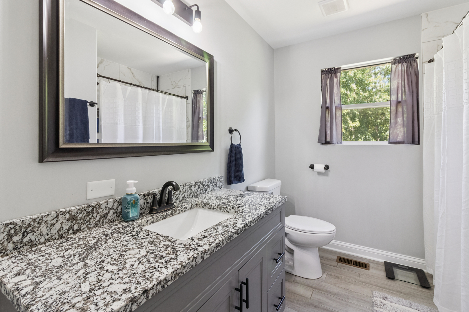 1243 Jericho Road Aurora, IL 60506 - Photo 14 of 25 a bathroom with a granite countertop sink toilet and mirror