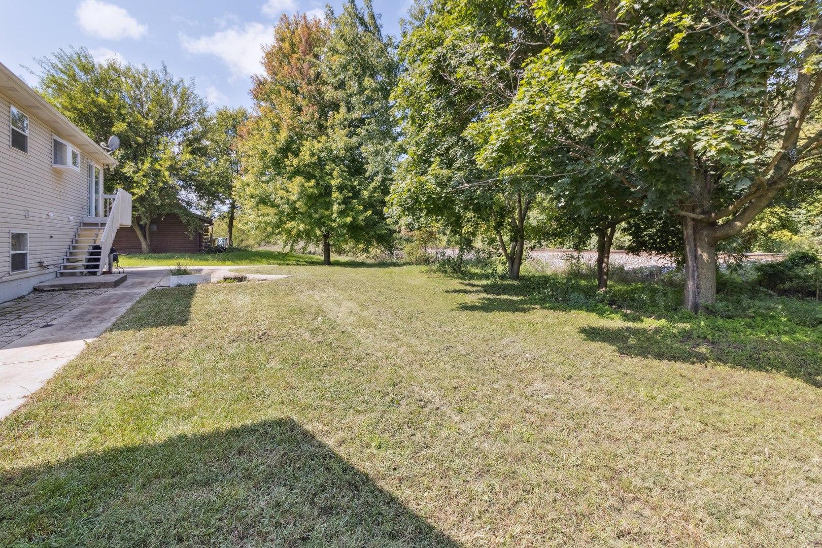 1243 Jericho Road Aurora, IL 60506 - Photo 23 of 25 a backyard of a house with lots of green space