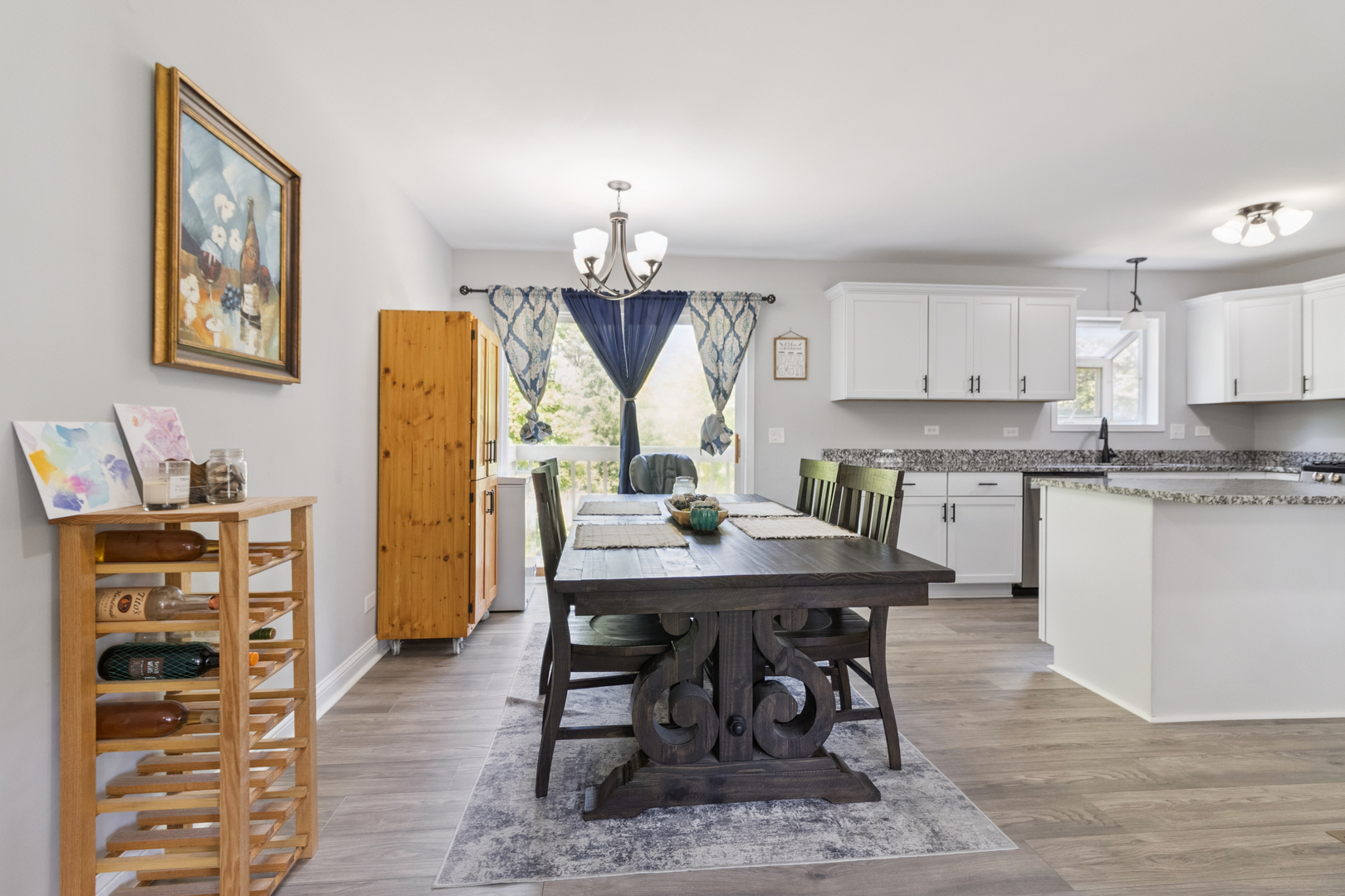 1243 Jericho Road Aurora, IL 60506 - Photo 6 of 25 a kitchen with stainless steel appliances granite countertop a stove a refrigerator a sink a dining table and chairs with wooden floor