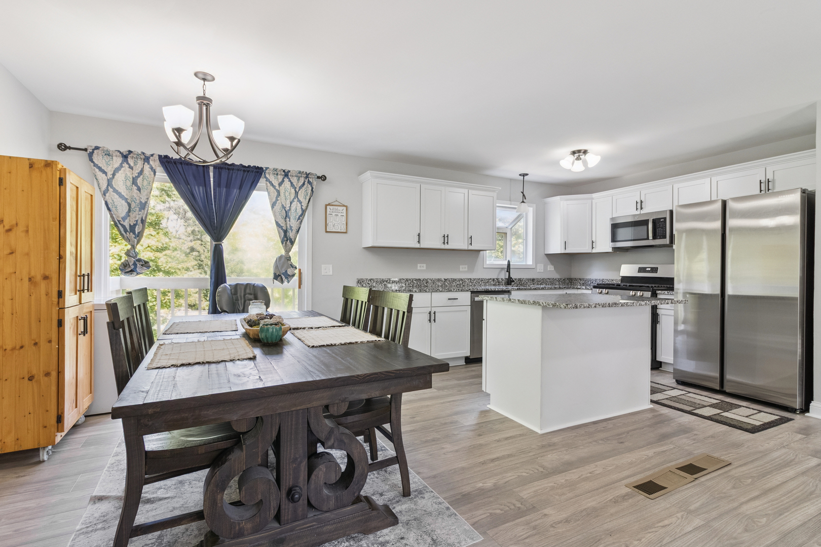 1243 Jericho Road Aurora, IL 60506 - Photo 7 of 25 a kitchen with a table chairs refrigerator and cabinets